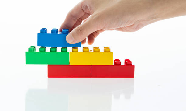 istock Human hand buildings toy bricks on white background 1148539064