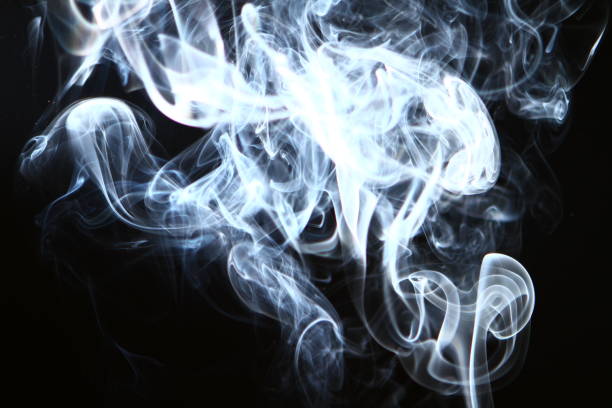 istock wonderful flowing light bright smoke on black background. 1148540794