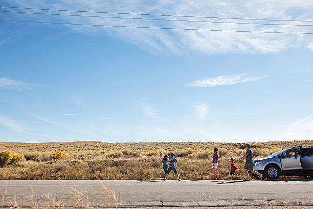 family with car on desert road - motor vehicle road trip western usa southern california 뉴스 사진 이미지