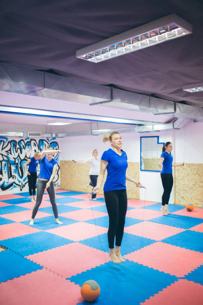 istock Group of athletic people using jump ropes for their workout 1148550276