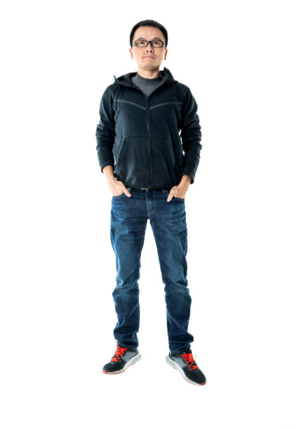 istock Man standing with hands in pockets on white background 1148551466