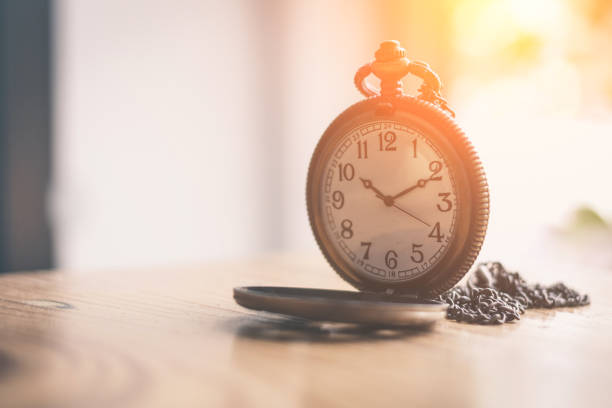 istock Old pocket watch on old wood background 1148552421