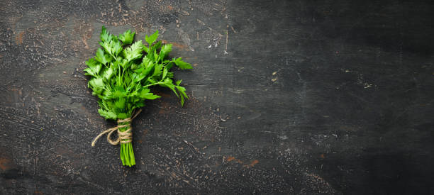 istock Fresh green parsley on the old background. Top view. free space for your text. 1148552521