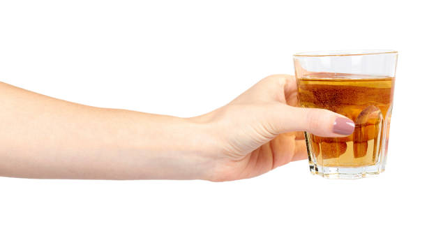istock Hand with fresh apple juice in a glass, healthy beverage. 1148557272