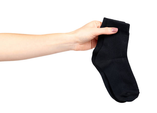 istock Hand with black cotton sock, foot clothing. 1148557968