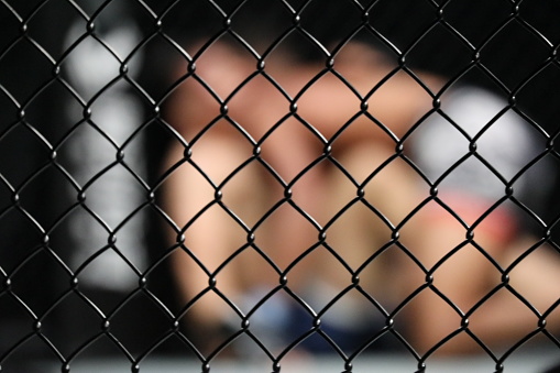 Blurred images of boxing in a cage.Use for website/banner and wall texture background