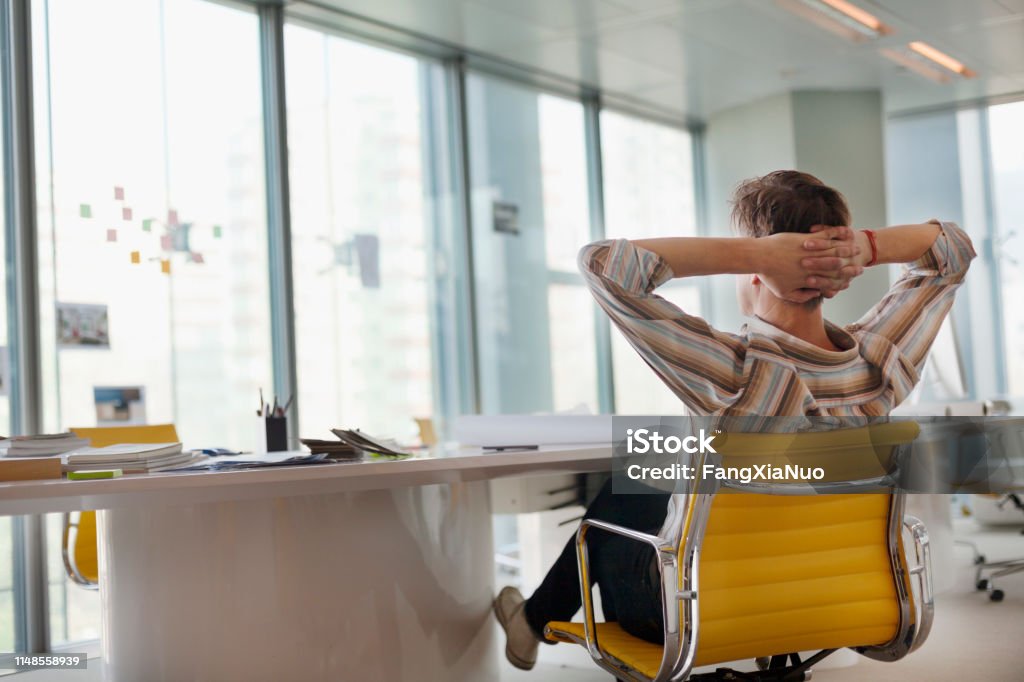 Mann sitzt im Designbüro aus dem Fenster - Lizenzfrei Büro Stock-Foto