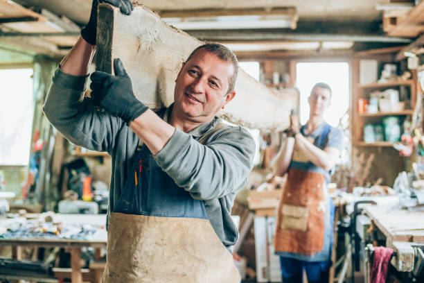 istock Carpenters carrying a wood plank 1148560123
