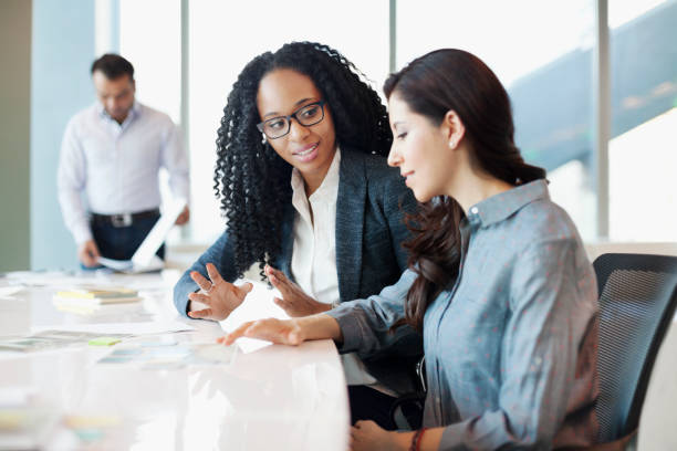 istock Woman discussing ideas with colleague at meeting table 1148560143