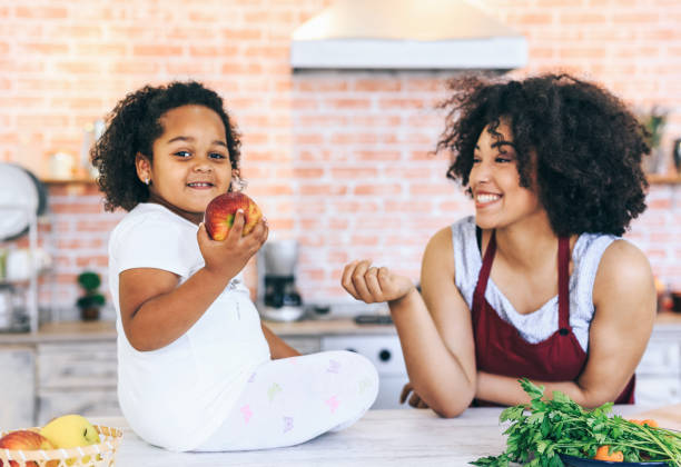istock Mother passes child an apple 1148561161