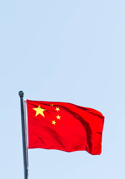 istock Chinese flag waving under blue sky 1148561366