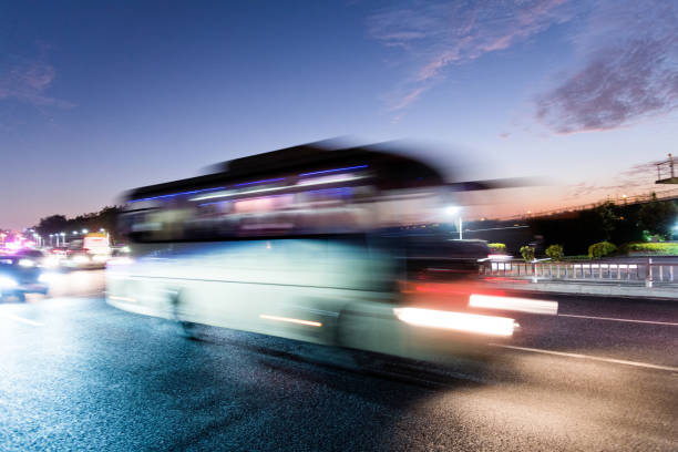 istock Bus driving on highway at dusk 1148562671