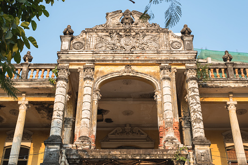 Exterior of the second floor of the Mansion or Villa Bodega, a half-ruined colonial-era building (1910-1920s) in Phnom Penh city center, Cambodia.