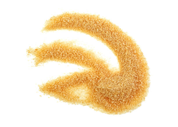 istock Brown cane sugar isolated on white background, top view. 1148563870
