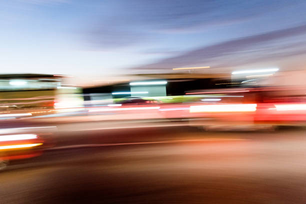 Cars driving on highway at dusk.