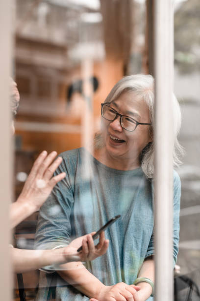 istock Two modern senior women are using social media at a cafe 1148564595