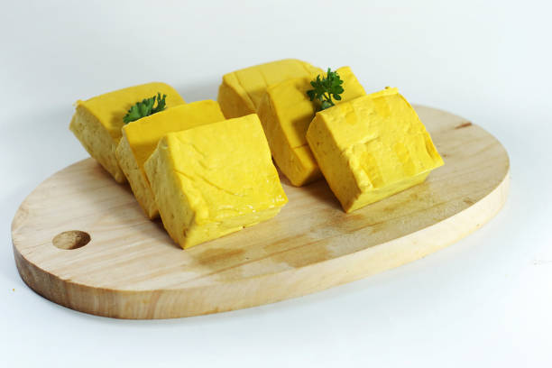 istock yellow tofu on cutting board isolated on white 1148565078