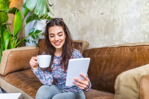 istock Candid image of a young woman using tablet computer in a cafe 1148567237