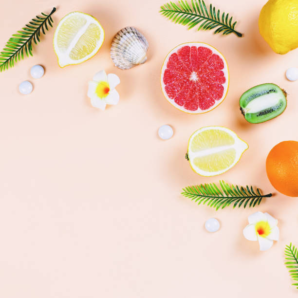 istock Summer tropical fruits frame on coral color background 1148568507