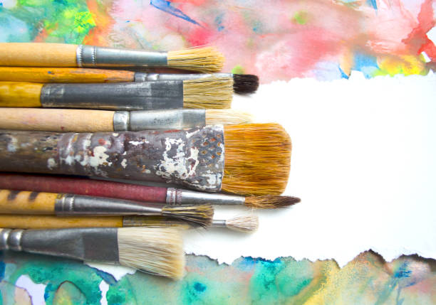 istock Paintbrushes on abstract colorful watercolor background with place for text. Blank for motivating quote, note, message. 1148572683