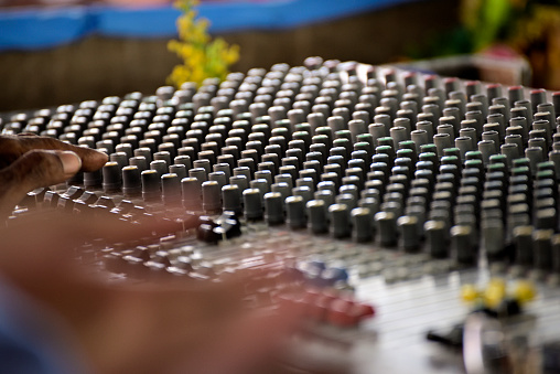 Close-up of sound mixer in a studio mixing sound.