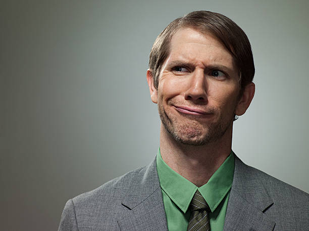 Confused mid adult businessman, portrait  frowning stock pictures, royalty-free photos & images