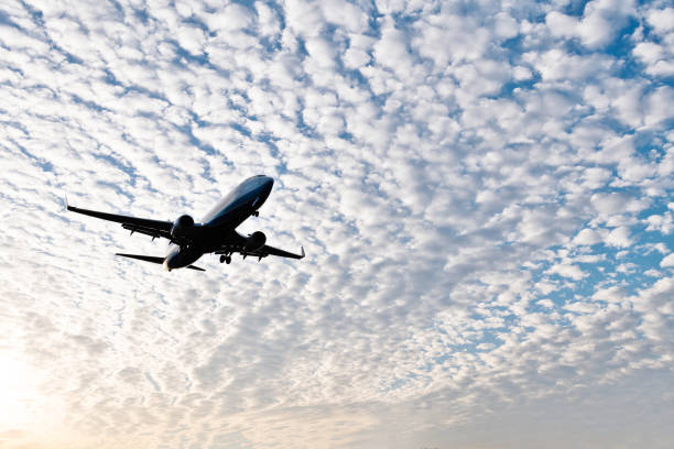 An airplane flying in cloud sky.
