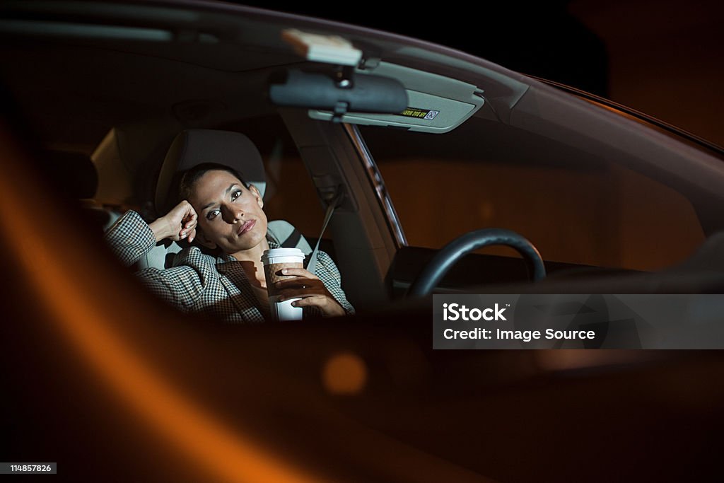 Businesswoman in car at night - Стоковые фото Женщины роялти-фри