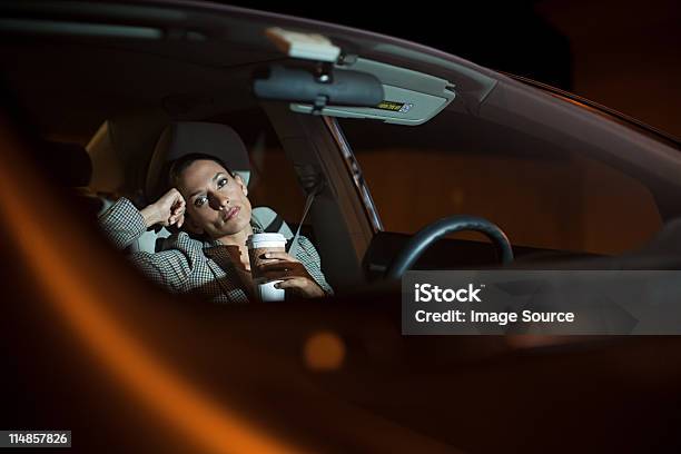 Businesswoman In Car At Night — стоковые фотографии и другие картинки Женщины - Женщины, Ночь, Салон машины