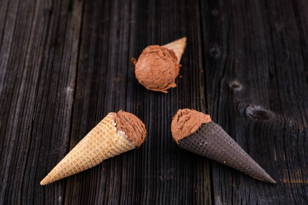 istock peach ice cream in wafer on wooden background 1148581148