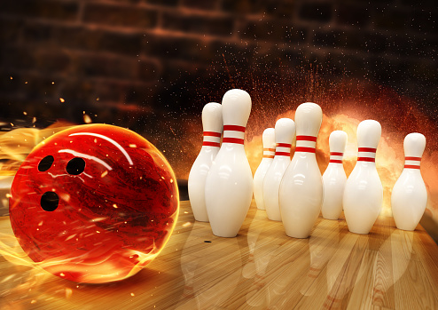 Bowling hit with fire ball rolling on the floor. Concept of success and win.