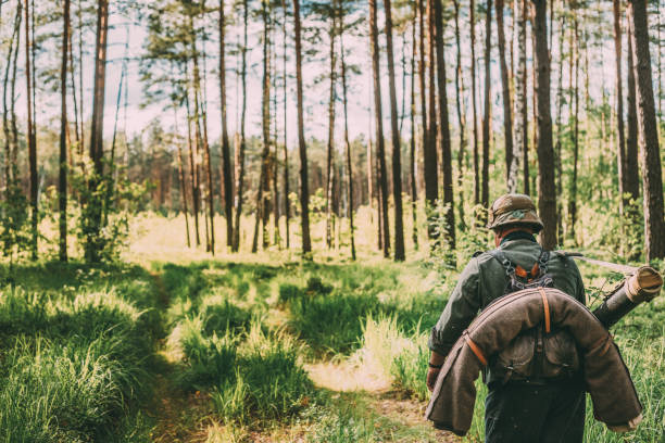 istock Rear View Of Soldier Walking On Trail In Forest 1148581289