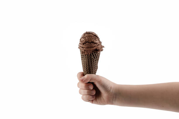 istock hand holding chocolate ice cream with chocolate cone isolated on white background 1148583136