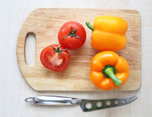 istock tomato orange pepper on the board isolated background 1148585011