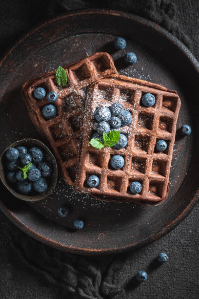 istock Homemade waffles with dark chocolate and fresh blueberries 1148587045