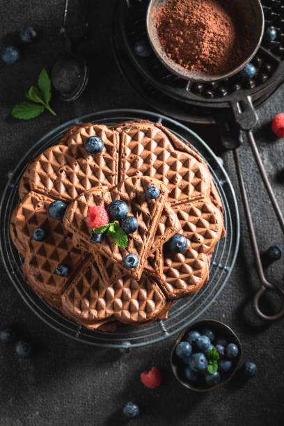Fresh waffles made of cocoa with fresh berries