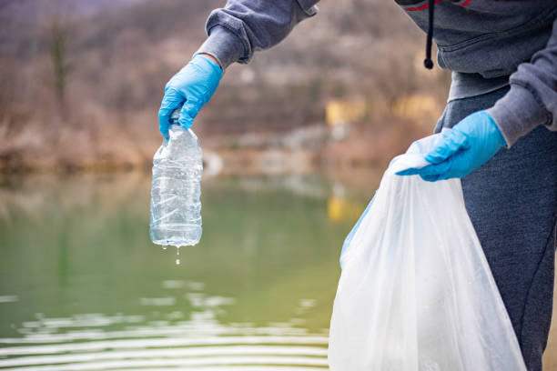 istock Adult Man Picking Up Trash From River and Riverbank 1148587683