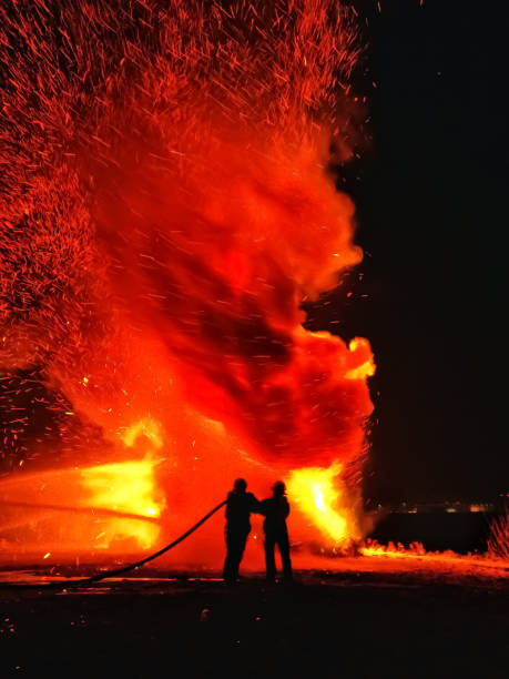 istock Firefighters battling bonfire on the beach 1148588454