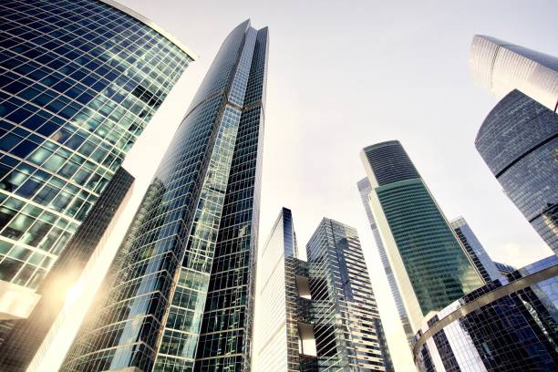 istock Office and residential skyscrapers against bright sun 1148588471