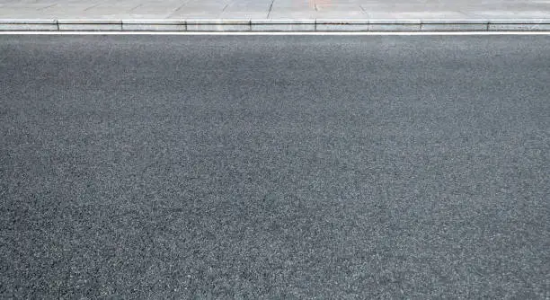 Photo of Rough asphalt road texture background