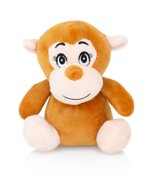 Monkey plushie doll isolated on white background with shadow reflection. Monkey plush stuffed puppet on white backdrop. Brown ape plushie toy. Colored stuffed monkey toy.