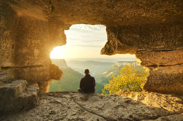 Man in cave mountain. stock photo