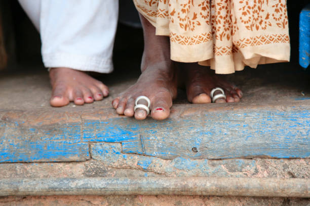 The legs of a poor married Indian woman The legs of a poor married Indian woman with traditional Ayurvedic rings on the second finger caste system stock pictures, royalty-free photos & images