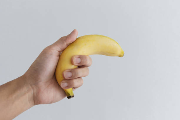 istock Hand holding banana, on white background 1148590523