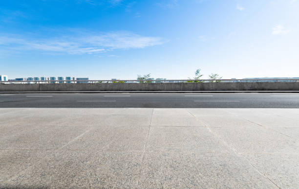 Empty asphalt road with buildings in the city