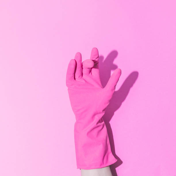 istock hand in pink rubber glove, showing gesture. Minimalism. 1148591688