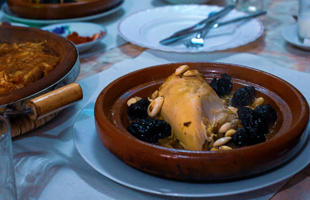 istock Slow-cooked chicken with prunes, almonds, onions and sprinkled with sesame, Moroccan tagine, 1148592632