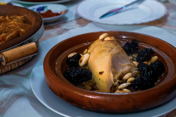 istock Slow-cooked chicken with prunes, almonds, onions and sprinkled with sesame, Moroccan tagine, 1148592766