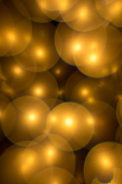 istock Decorative golden color bubbles bokeh on a black background. Lights for christmas 1148592886