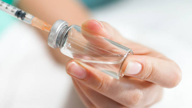 istock Macro image of nurse preparing medication in glass ampule 1148593821